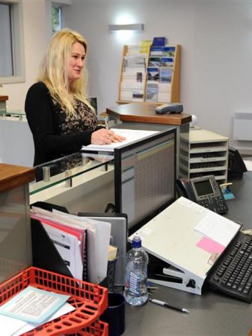 Julie Eckhold (left) talks to records officer Alysha Bennett as she takes a look at the Otago...