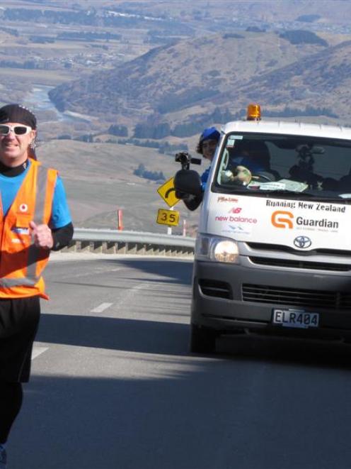 Jup Brown  jogs  up the Crown Range road above Arrowtown in early September  while his support...