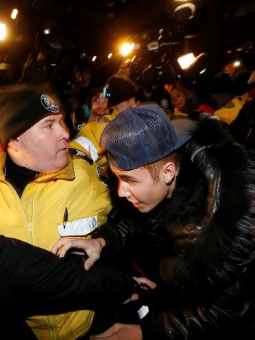 Justin Bieber arrives at a police station in Toronto where he was charged with assaulting a...