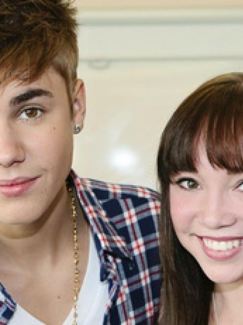Justin Bieber, pictured with Starship patient Makenzie Perry, is helping to promote the hospital...