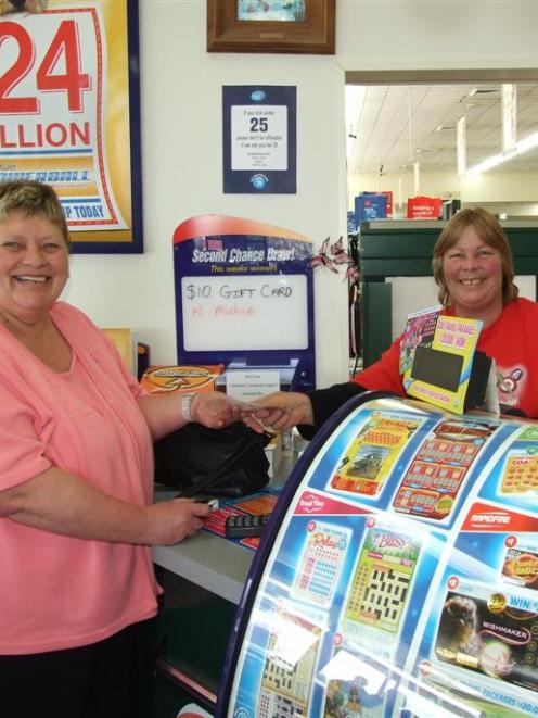 Kaitangata Lotto winner Irene Carson buys a ticket for tonight's $24 million Lotto Powerball draw...
