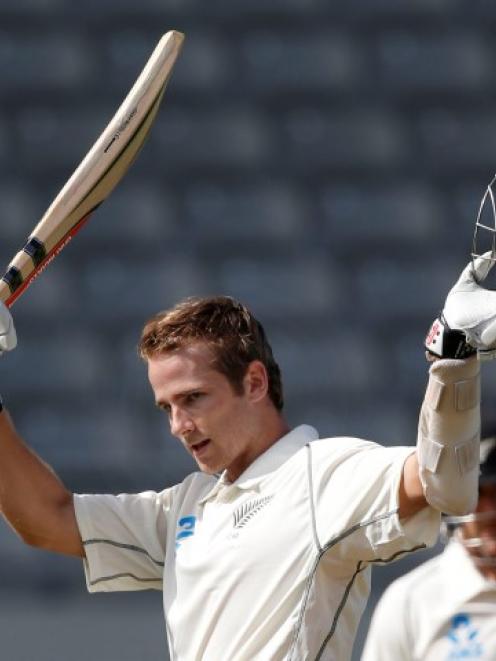 Kane Williamson celebrates his century in the first test against India at Eden Park in Auckland....