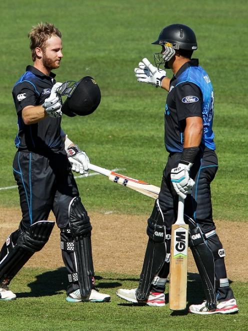 Kane Williamson (L) receives congratulations from Ross Taylor after reaching his century against...