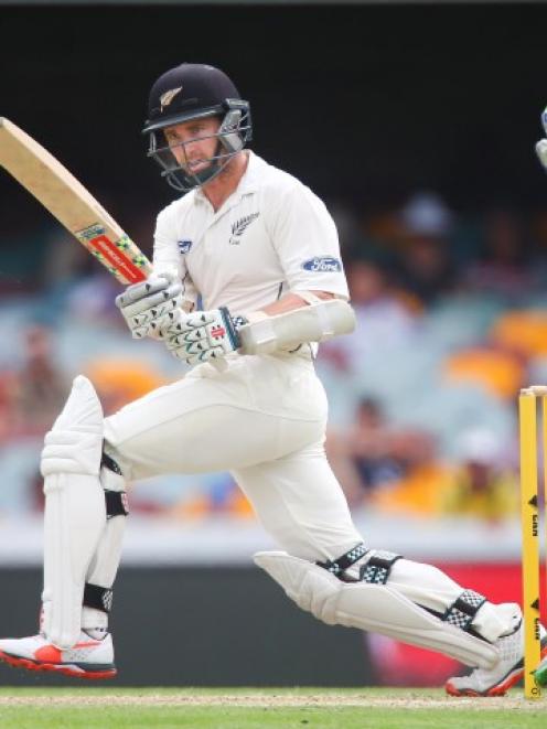 Kane Williamson plays a sweep shot during the first test in Brisbane. Photo Reuters
