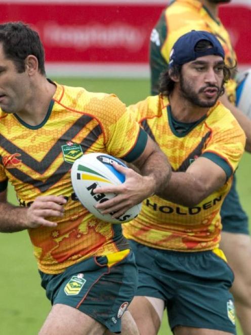 Kangaroos captain Cameron Smith (L) and Johnathan Thurston warm-up during the Anzac test Captain...