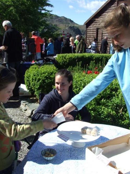Kate Brown (8), of Bluff, buys some Russian fudge from stallholders Sarah Henderson (left) and...