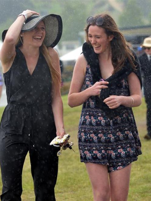 Kate Holden (18) and Harriet Keown (17) brave the rain at Wingatui. Photo by Peter McIntosh