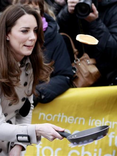 Kate Middleton flips a pancake on a visit to Belfast earlier this month.(AP Photo/Peter Morrison)