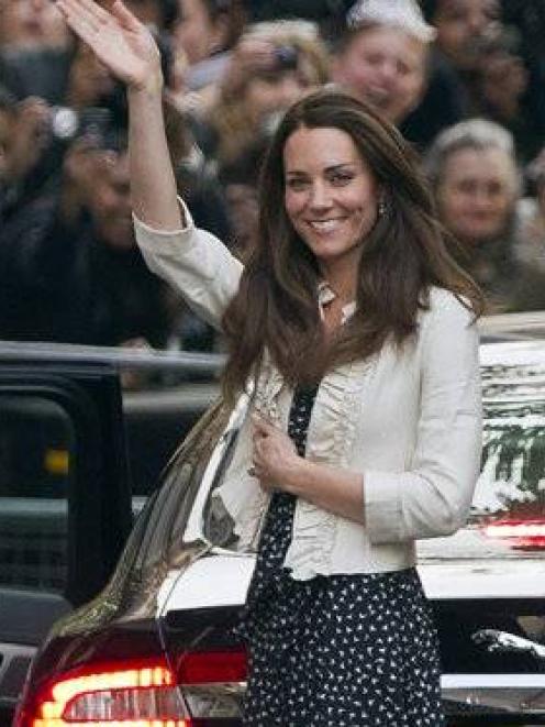 Kate Middleton waves to the crowds gathered outside the Goring Hotel in London yesterday ahead of...