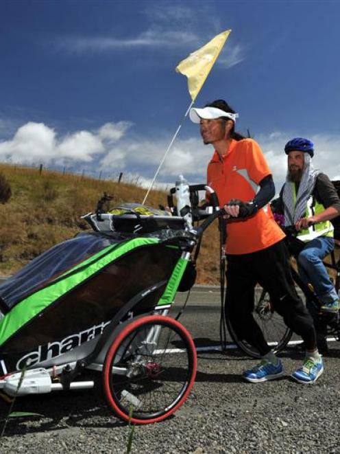 Katzhiko Takashige, of Japan, accompanied by Paul Gourlie, of Dunedin, makes his way up the...