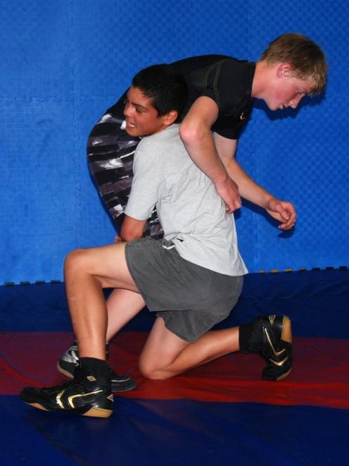 Kawana Tokona (white shirt) wrestles with Ryan van der Lem at the Todd Group Gymnasium. Photo by...
