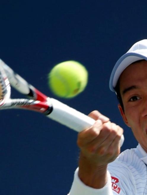 Kei Nishikori hits a return to Novak Djokovic during their US Open semifinal match. REUTERS/Ray...