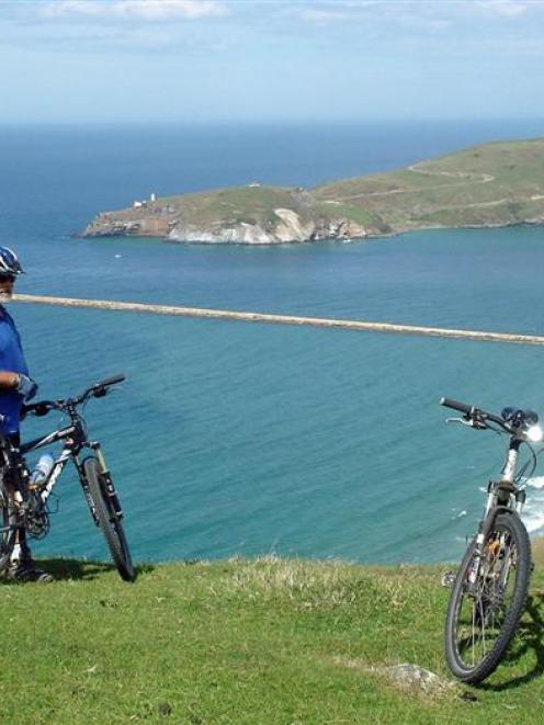 Keith Munro takes in the view from the top of the Heyward Pt track with the Mole and Taiaroa Head...
