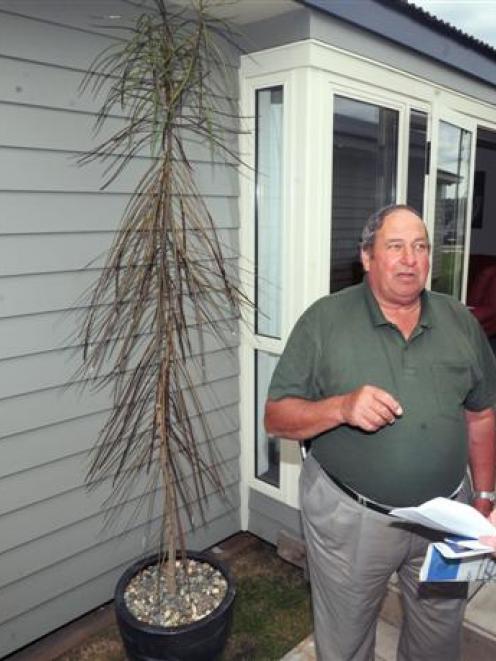 Keith Simon, of Taieri Mouth (left) talks to Metro Realty's Mark Stevens after becoming the owner...