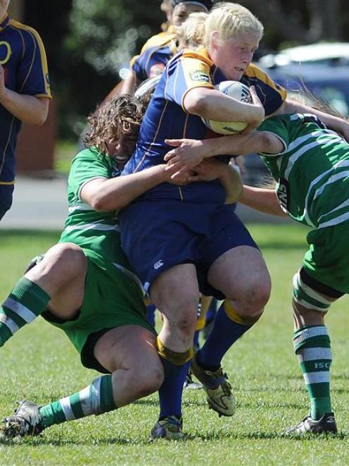 Kerry Stodart, of Otago Spirit, is tackled by Ruth McKay (left) and Zoe Whatarau, od Manawatu, in...