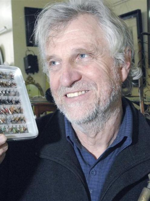 Kevin Hayward of Hayward Auction House with a one of the many boxes of handmade flies and a...