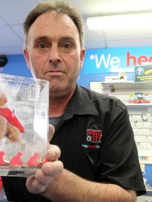 Kevin Knox, owner of Video Ezy Greenmeadows, Napier, with a charity donation box for the Royal...