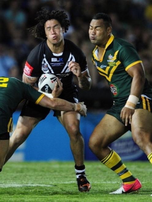 Kevin Proctor of the Kiwis is tackled by Darius Boyd and Tony Williams of the Kangaroos during...