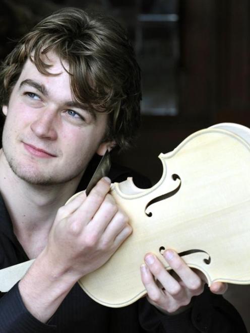 Khris Ansin works on a violin at his Dunedin home yesterday. Photo by Gerard O'Brien.