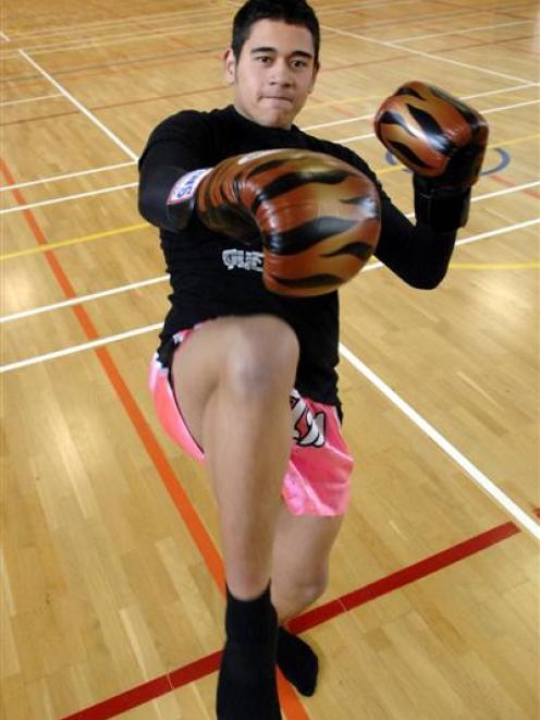 Kickboxer Cleveland Falanitule works out at the Logan Park High School gymnasium yesterday. Photo...