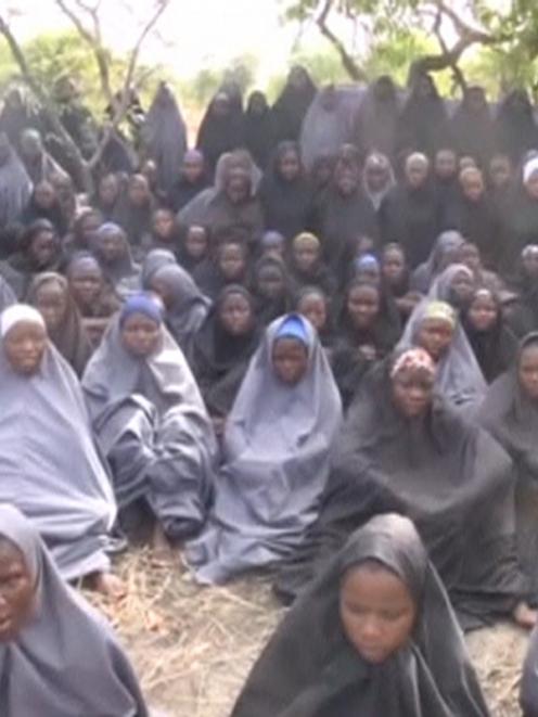 Kidnapped schoolgirls are seen at an unknown location in this still image taken from an undated...