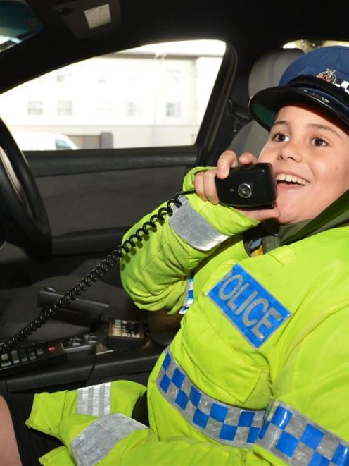 Kieran Rotarangi (9), of Dunedin, sees if the job fits during the New Zealand Police Open Day at...