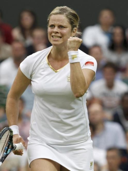 Kim Clijsters of Belgium celebrates after defeating Andrea Hlavackova of the Czech Republic in...