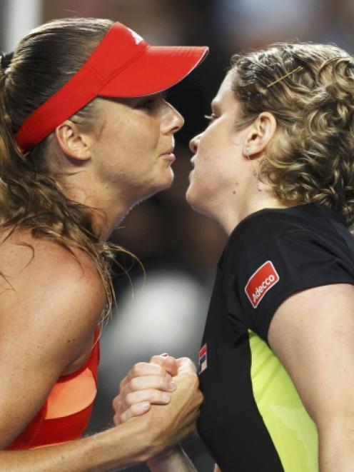 Kim Clijsters of Belgium (R) and Daniela Hantuchova of Slovakia kiss after their match at the...