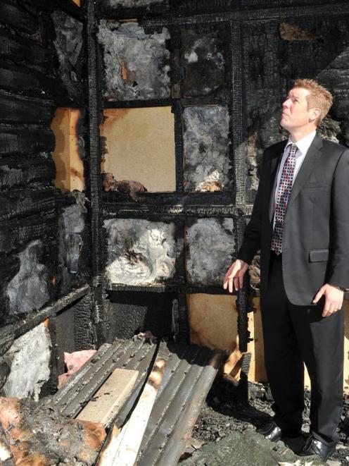 King's High School rector Dan Reddiex examines the fire-damaged gymnasium yesterday. Photo by...