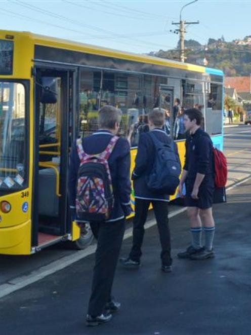 Kings and Queens High School pupils board school buses in Bayview Rd, yesterday afternoon. Photo...