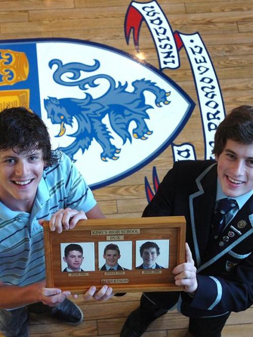 Kings High School 2006 dux Bonar Robertson (left) and his brother Bede (2008 dux) hold a plaque...