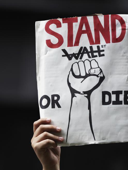 Kristina St. George holds aloft a protest sign in Zucotti Park during a demonstration by the...