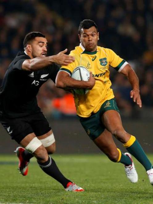 Kurtley Beale tries to get past All Black flanker Liam Messam during the second test at Eden Park...