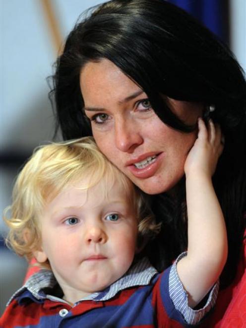 Kylee Guy, wife of murdered Feilding dairy farmer Scott Guy with son Hunter at a press conference...