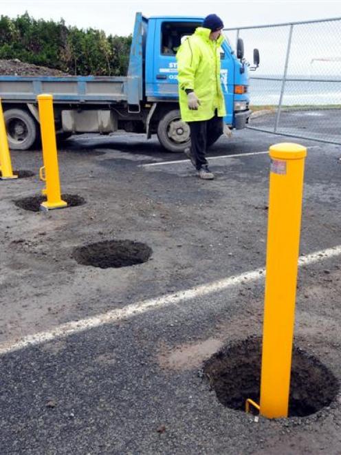 Labourer Dave Arthur works on John Wilson Ocean Dr, where contractors are installing bollards to...