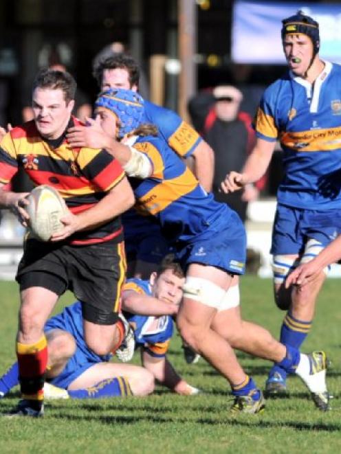 Lachie Moore (Zingari-Richmond) escapes the tackle of Taieri flanker Willis Scott at Montecillo...