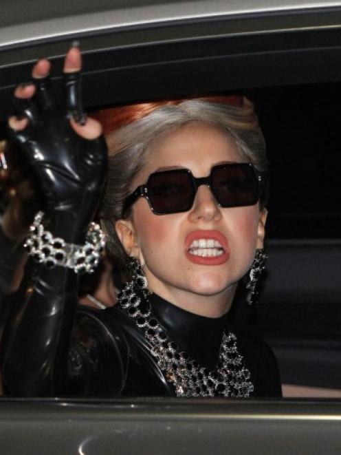 Lady Gaga waves upon her arrival at Don Muang Airport for her concert in Bangkok, Thailand....