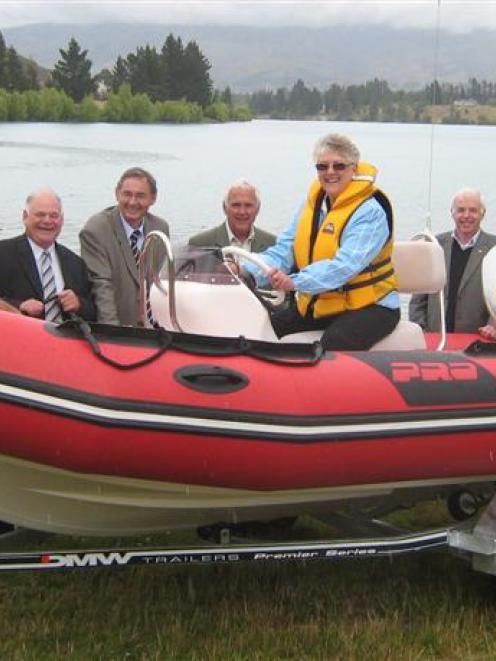 Lake Dunstan Boat Club vice-commodore Roger Gibson (left) sits in the bow of the club's new...
