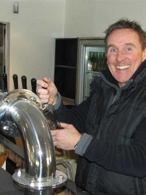 Lake Hawea Hotel co-owner Mike Smith  testing  beer taps ahead of the reopening of the hotel's...