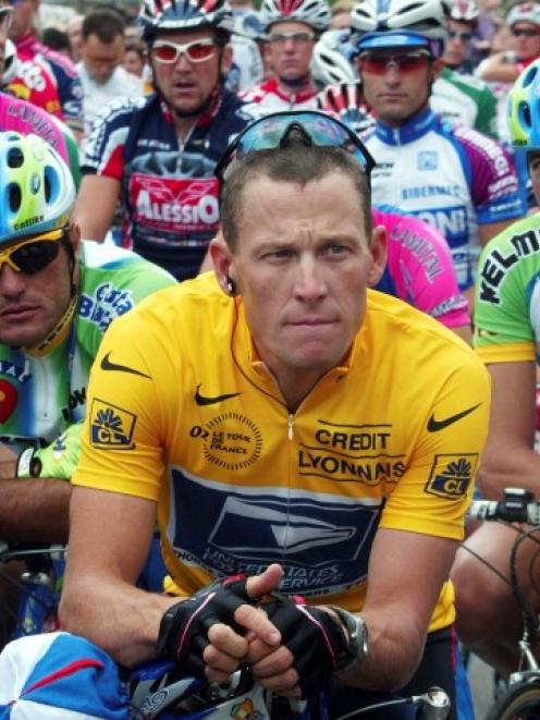 Lance Armstrong of the US waits in front of the pack of riders for the start of the 89th Tour de...