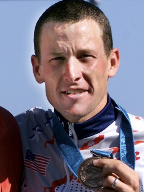 Lance Armstrong poses with his bronze medal after the men's Olympic individual time trial in...