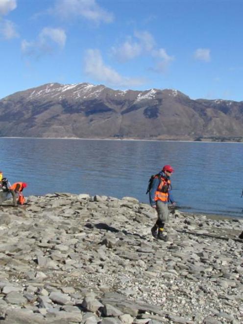 LandSAR Wanaka search and rescue volunteers Peter Reed (left) and John Burke head off along the...