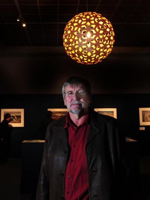 Landscape photographer Andris Apse among his Antarctic images on display at Otago Museum. Photo...