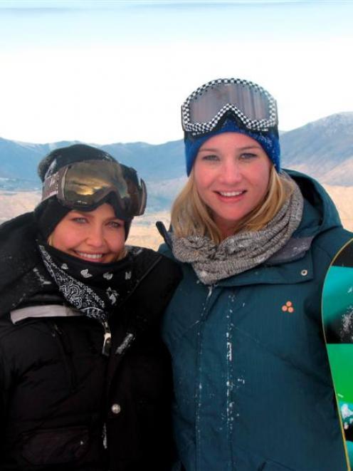 Lara Bingle (left) and Hayley Holt pause for a photo during filming at Coronet Peak yesterday....