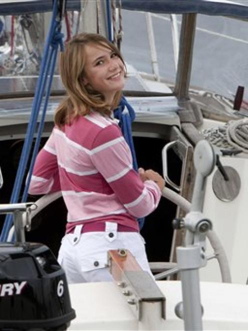 Laura Dekker poses for the media on her boat Guppy in Den Osse, south-west Netherlands, Tuesday,...