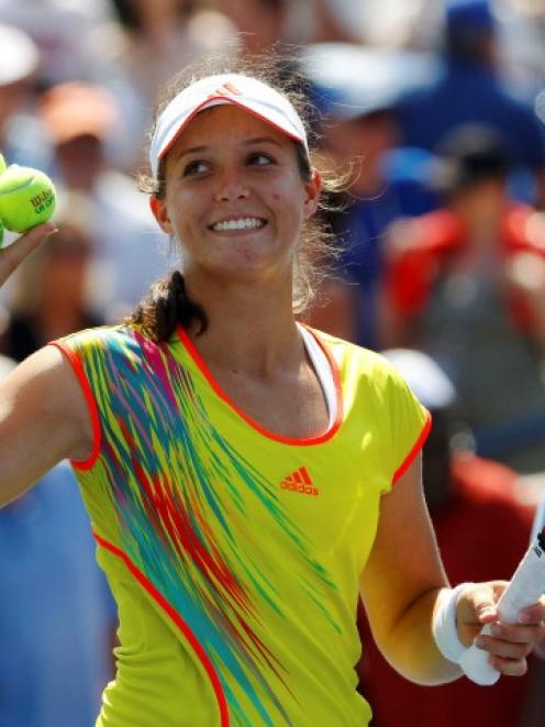 Laura Robson of Britain prepares to hit balls to fans after defeating Li Na of China during their...