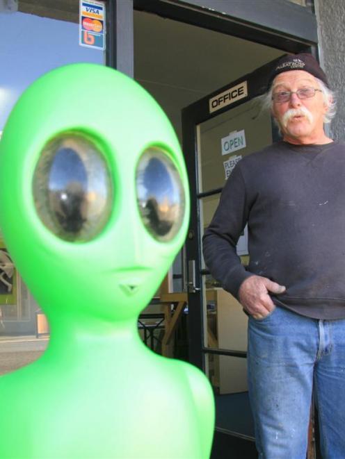 Lawrence artist Graeme Furness with the little green man outside his Exit Studio gallery in the...