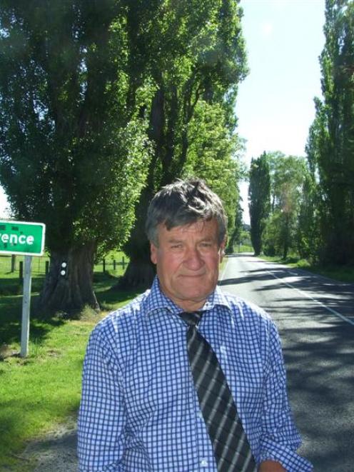 Lawrence-Tuapeka Community Board chairman Geoff Davidson with  the Lombardy poplars which line...