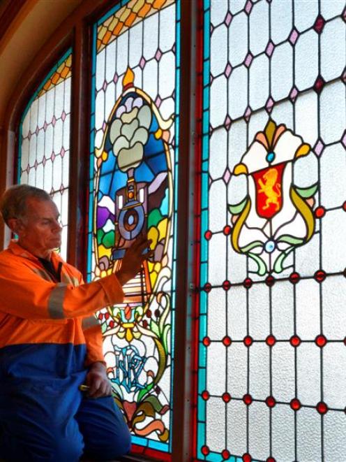 Leadlights & Lamps owner Kevin Casey gets ready yesterday to dismantle the damaged leadlight...