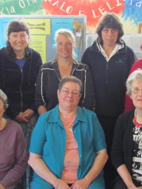 Learning to speak English by singing at Literacy North Otago are, standing, from left, Yumi...